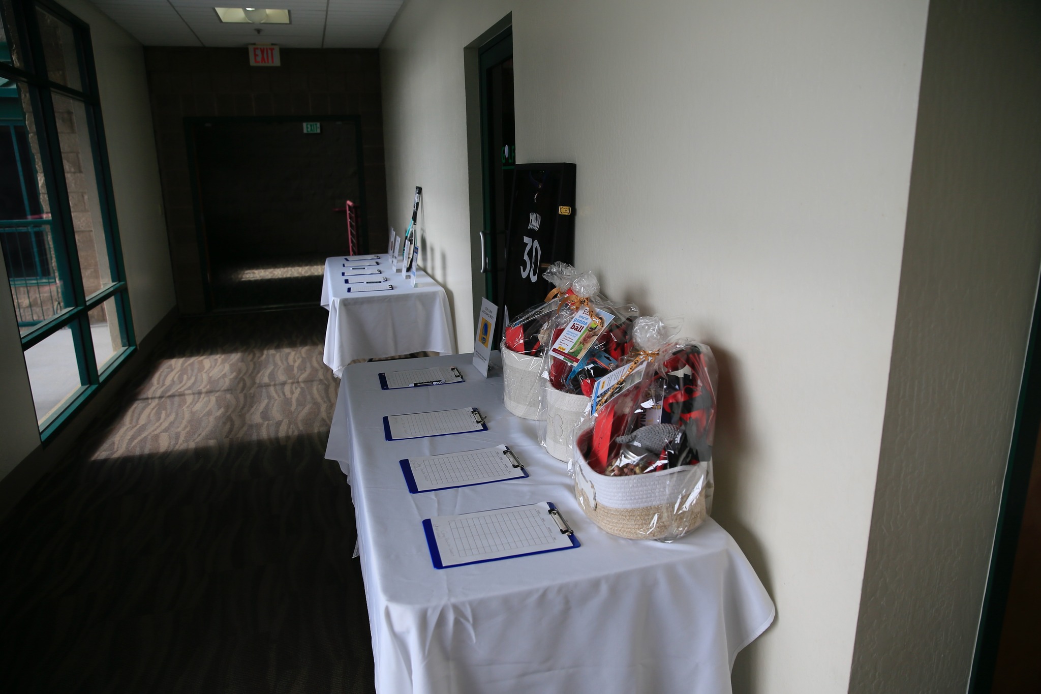 Silent auction tables with gear and gift baskets
